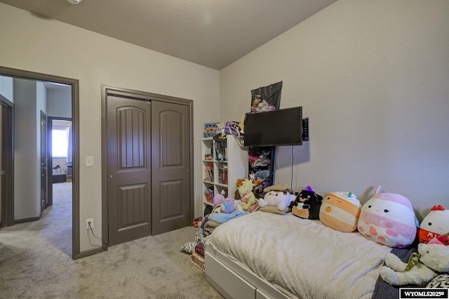 bedroom featuring a closet and carpet flooring