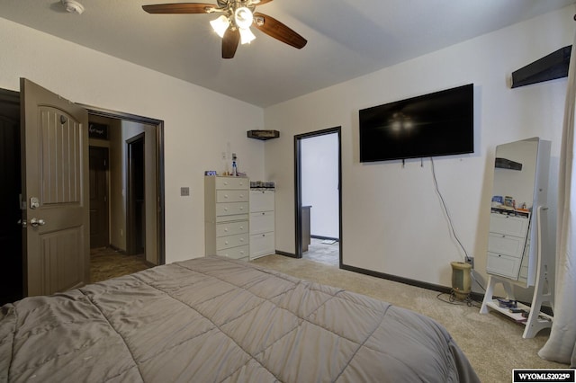 bedroom with light carpet, baseboards, and a ceiling fan