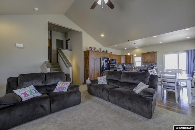 living area with ceiling fan, recessed lighting, wood finished floors, lofted ceiling, and stairs