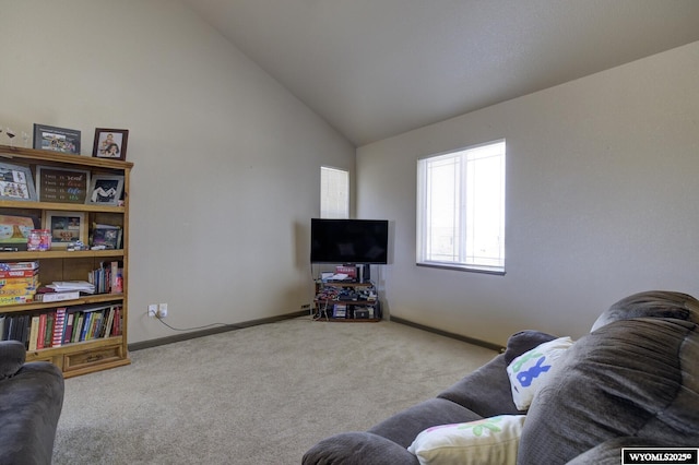 living area featuring carpet floors, baseboards, and high vaulted ceiling