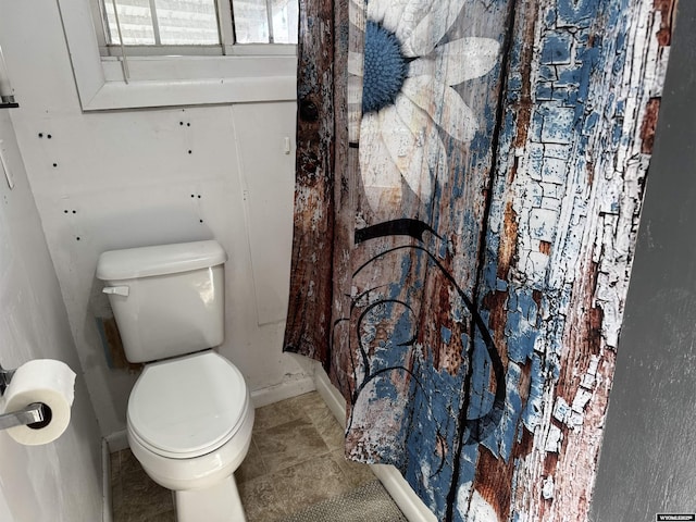 bathroom with toilet and tile patterned floors