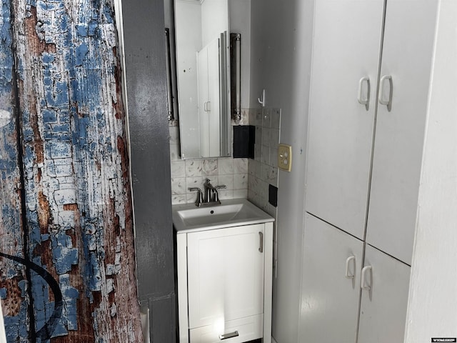 bathroom with vanity, decorative backsplash, and tile walls