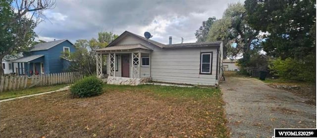 bungalow-style home with fence