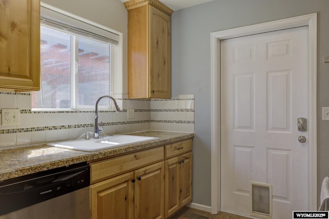 kitchen featuring tasteful backsplash, stainless steel dishwasher, a sink, and visible vents