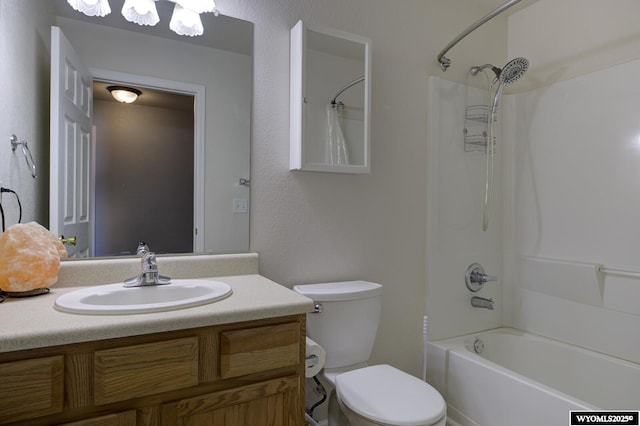 bathroom with vanity, bathtub / shower combination, and toilet