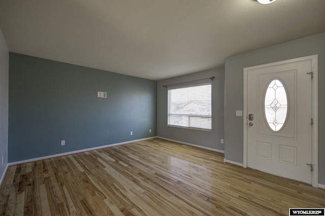 entrance foyer featuring light wood-style floors and baseboards