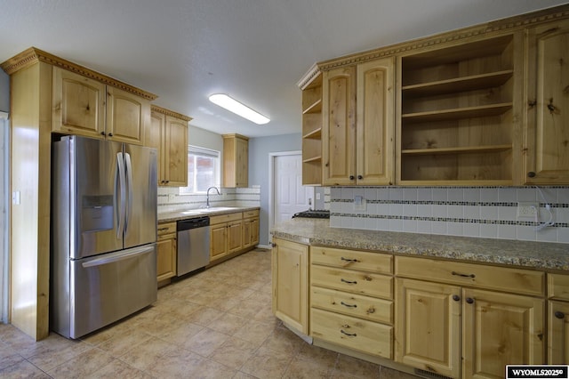 kitchen with tasteful backsplash, open shelves, a sink, stainless steel appliances, and light brown cabinets