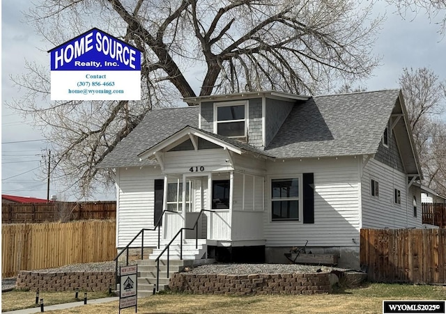 410 E Monroe Ave, Riverton, WY 82501 - view of front of house featuring roof with shingles and fence