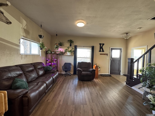 410 E Monroe Ave, Riverton, WY 82501 - living room with a textured ceiling, wood finished floors, baseboards, and stairs