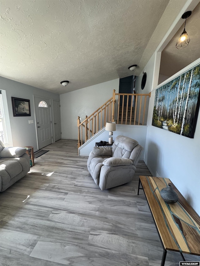 325 Hathaway Ave, Evanston, WY 82930 - living area featuring a textured ceiling, wood finished floors, and stairway