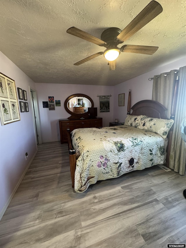 325 Hathaway Ave, Evanston, WY 82930 - bedroom featuring baseboards, a ceiling fan, wood finished floors, and a textured ceiling