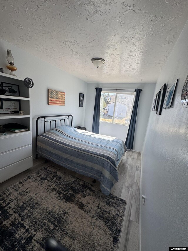 325 Hathaway Ave, Evanston, WY 82930 - bedroom with wood finished floors and a textured ceiling