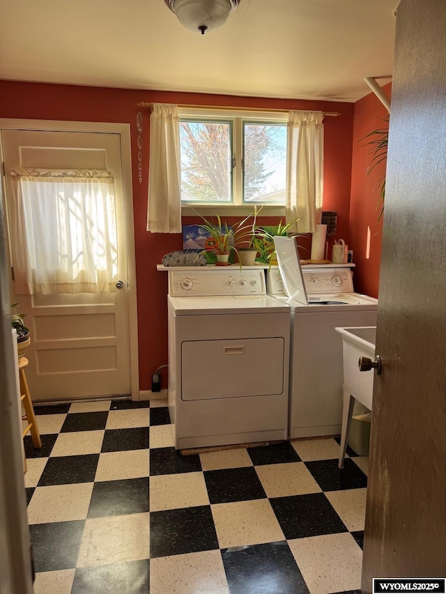 washroom featuring washer and dryer, plenty of natural light, laundry area, and light floors