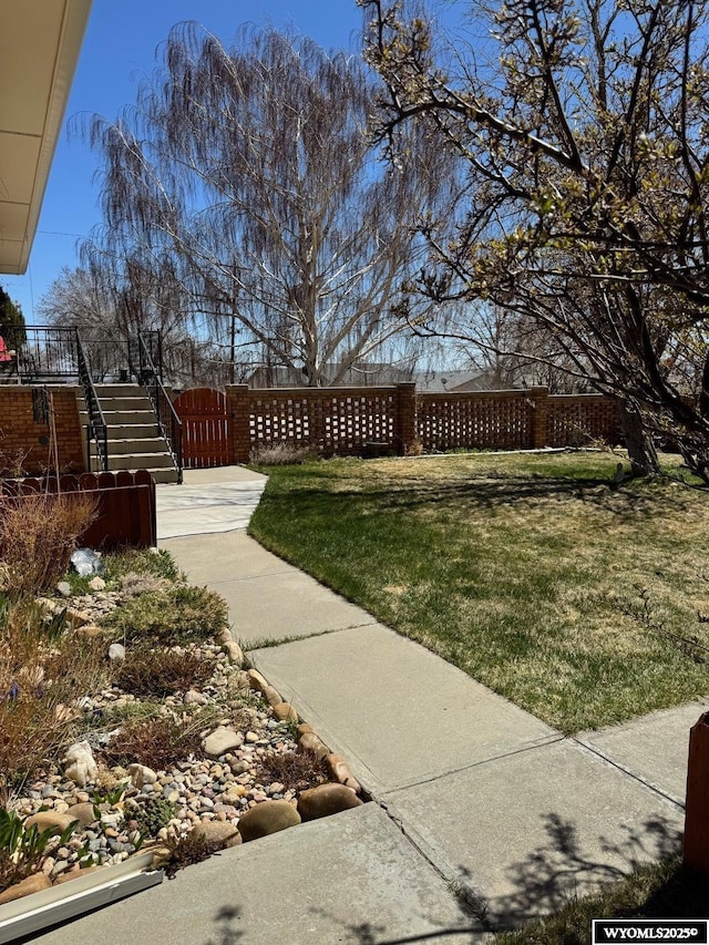 view of yard with stairway and fence