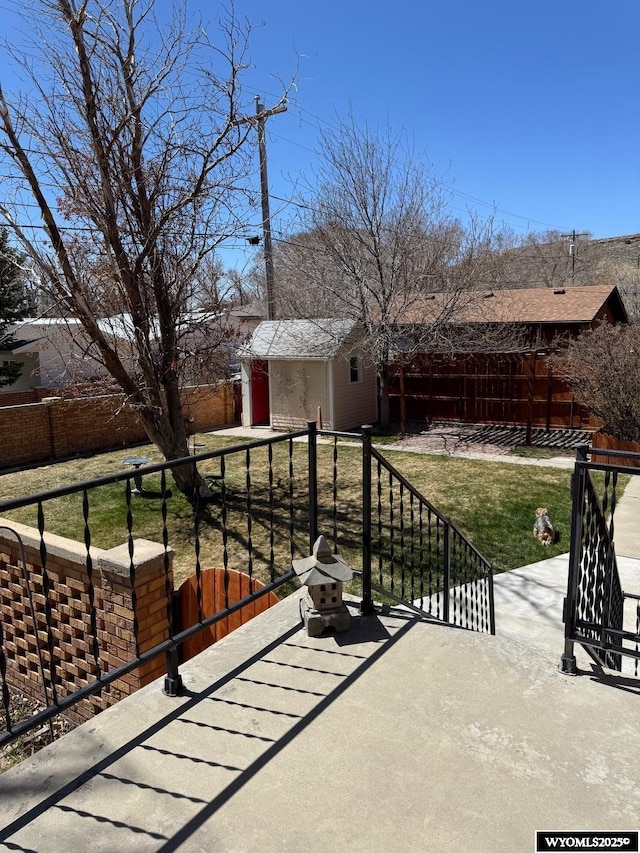 view of patio / terrace with a fenced backyard and an outdoor structure