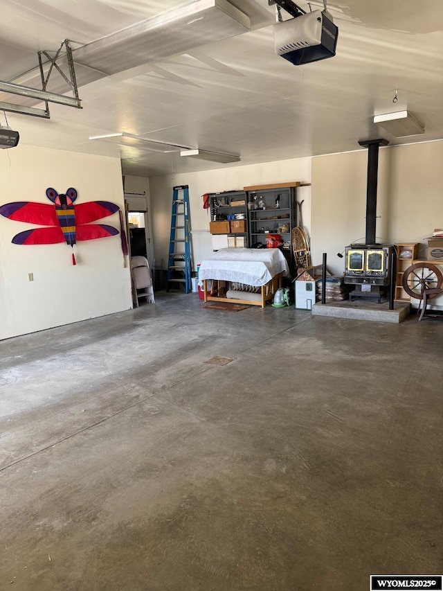 garage with a wood stove and a garage door opener