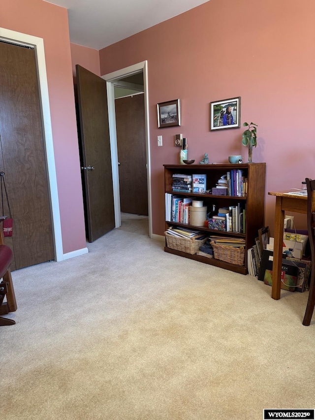 interior space with carpet flooring and baseboards
