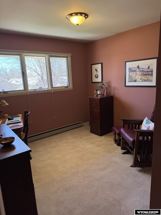 office space with light carpet and a baseboard heating unit