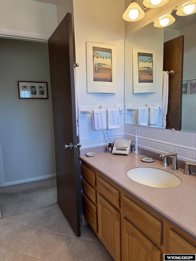 bathroom with tile patterned floors, vanity, and baseboards