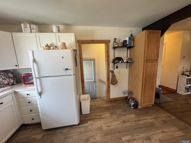 117 W Madison, Riverton, WY 82501 - kitchen with light countertops, white cabinetry, freestanding refrigerator, and wood finished floors