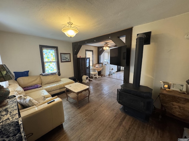 117 W Madison, Riverton, WY 82501 - living room with a wood stove, a ceiling fan, wood finished floors, and a healthy amount of sunlight