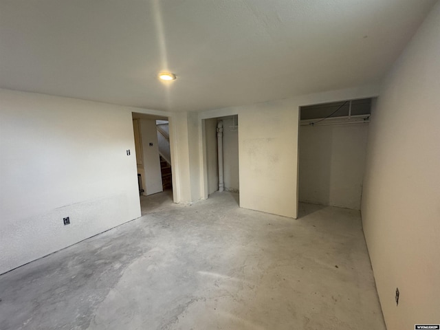 117 W Madison, Riverton, WY 82501 - unfurnished bedroom featuring concrete flooring and multiple closets