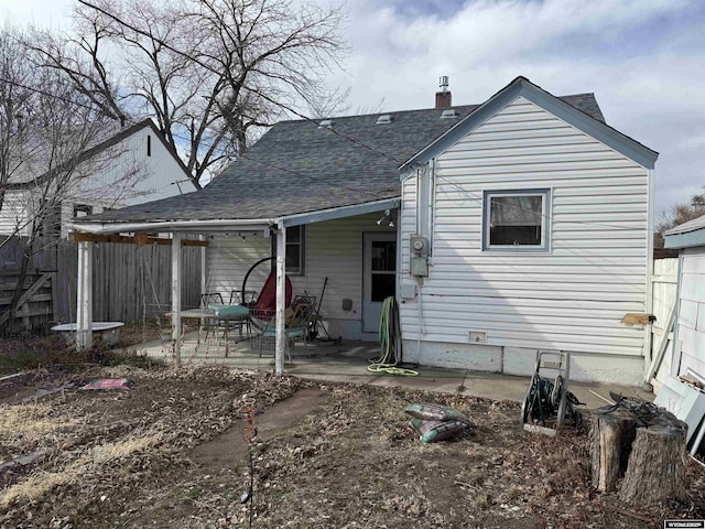 117 W Madison, Riverton, WY 82501 - rear view of property with a patio area, fence, a shingled roof, and a chimney