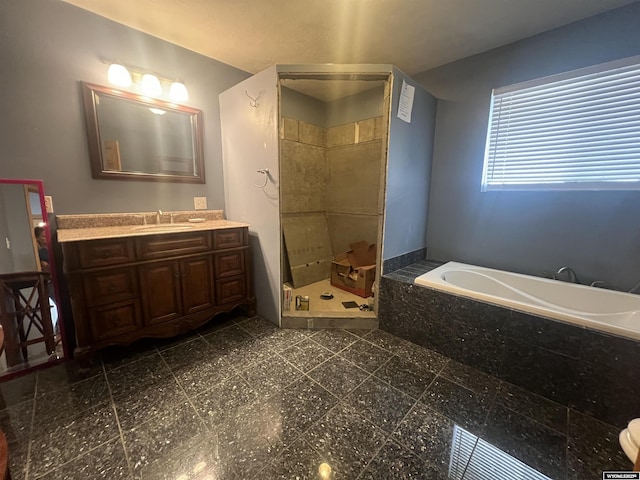 bathroom with a bath, a stall shower, vanity, and granite finish floor