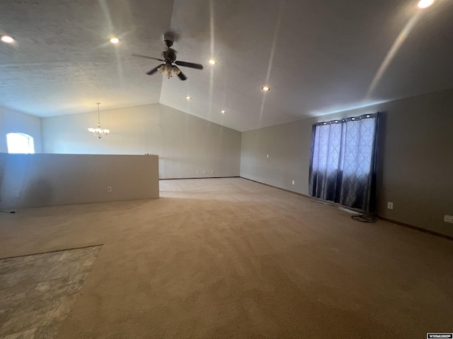 empty room with recessed lighting, lofted ceiling, light carpet, and ceiling fan with notable chandelier