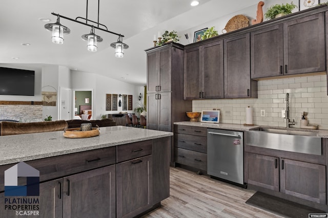 kitchen featuring stainless steel dishwasher, tasteful backsplash, dark brown cabinets, a sink, and open floor plan