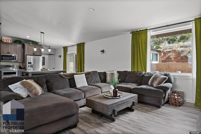 living room with light wood-style floors and baseboards