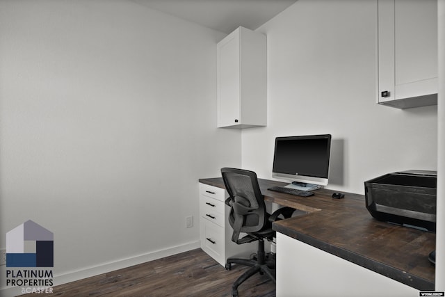 home office featuring baseboards and dark wood finished floors