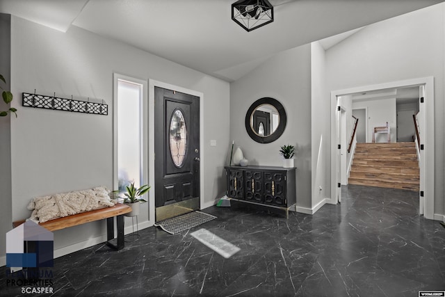 entryway with baseboards, stairway, marble finish floor, and vaulted ceiling