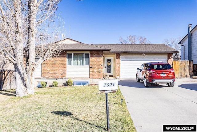 view of front of property featuring driveway, an attached garage, a front yard, brick siding, and fence
