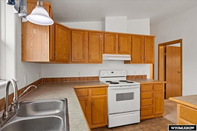 kitchen with brown cabinets, a sink, under cabinet range hood, vaulted ceiling, and white range with electric cooktop