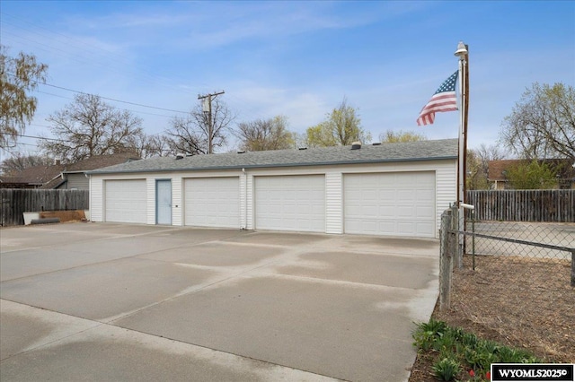 detached garage featuring fence