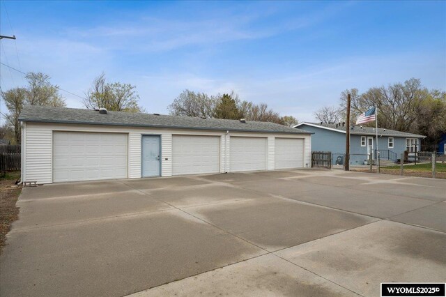 detached garage featuring fence
