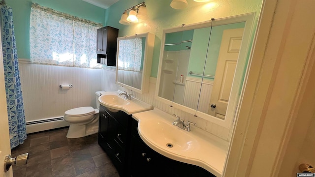 bathroom with baseboard heating, a wainscoted wall, a sink, and curtained shower