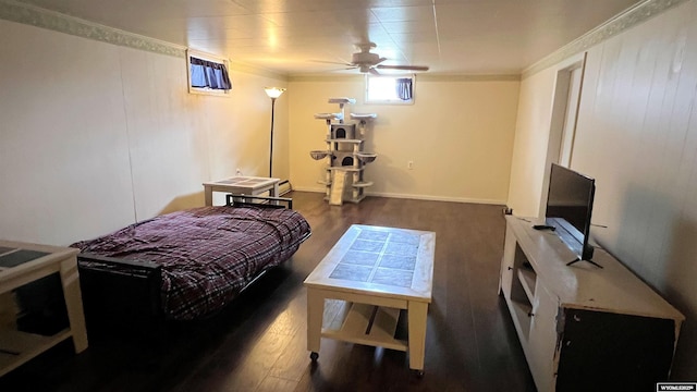 bedroom with wood finished floors and crown molding