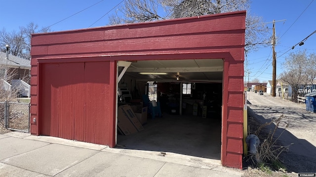 view of outdoor structure with a garage, an outbuilding, and driveway