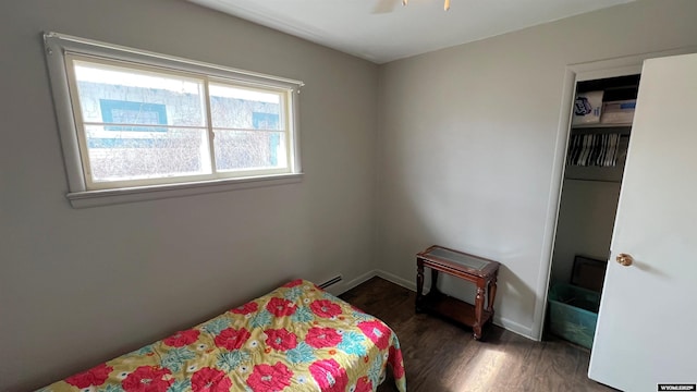 bedroom with baseboards and wood finished floors