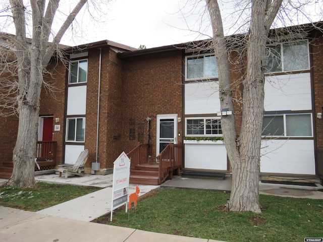 townhome / multi-family property with brick siding