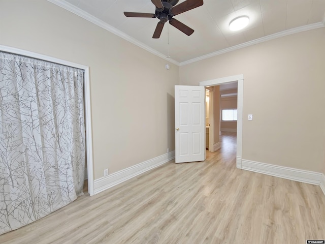 unfurnished room with baseboards, light wood-style floors, ceiling fan, and crown molding