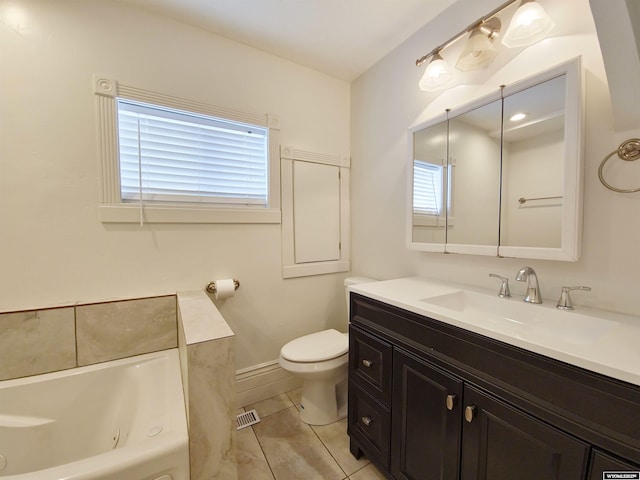 bathroom with a healthy amount of sunlight, toilet, a tub with jets, and vanity