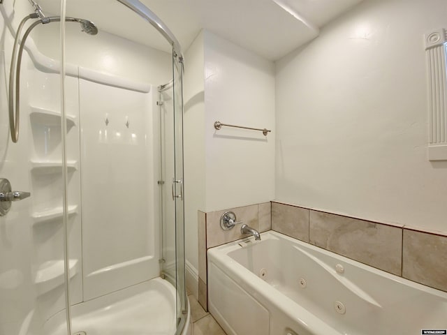 bathroom with a jetted tub and a stall shower
