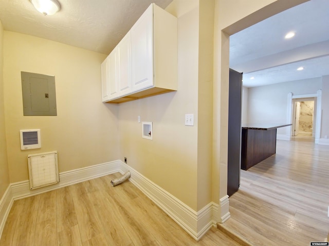 clothes washing area featuring washer hookup, light wood-style floors, electric panel, baseboards, and recessed lighting