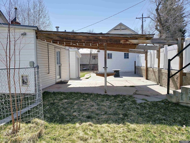 back of house featuring fence, a yard, and a patio