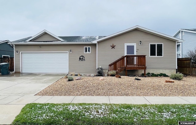 single story home featuring concrete driveway, fence, a shingled roof, and a garage