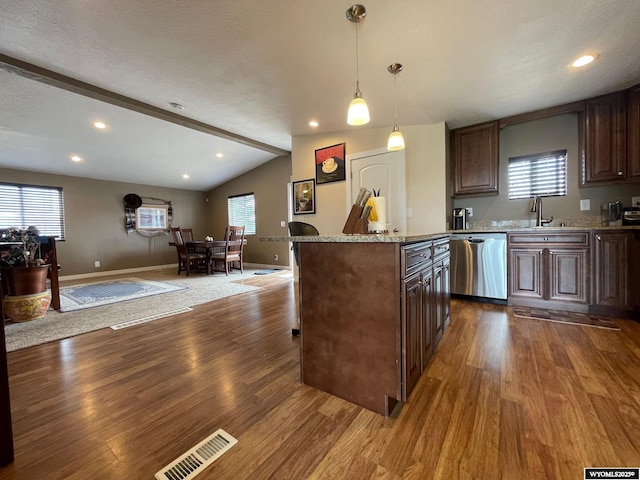 kitchen featuring wood finished floors, visible vents, stainless steel dishwasher, lofted ceiling with beams, and open floor plan