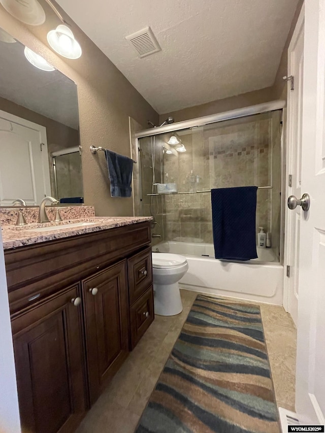 full bath featuring tile patterned flooring, enclosed tub / shower combo, visible vents, toilet, and vanity